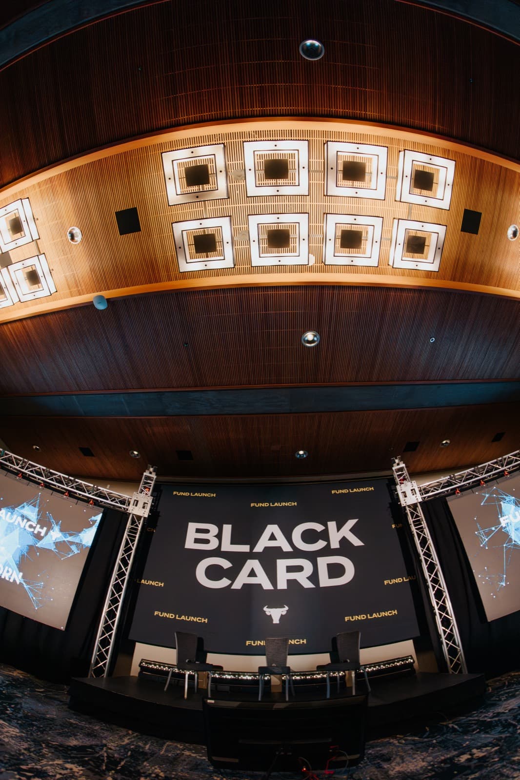 Black Card event branding displayed on a large screen in a theater setting.