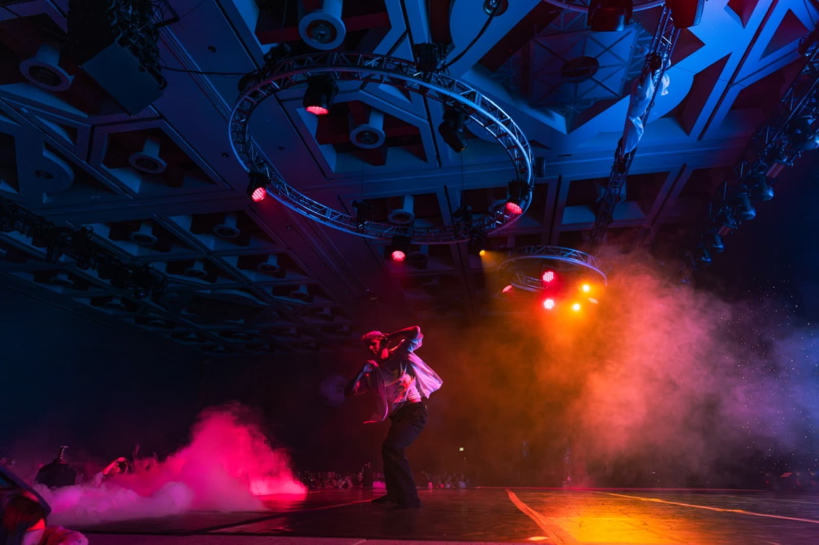GENTRI concert scene with magenta lighting and atmospheric stage effects.