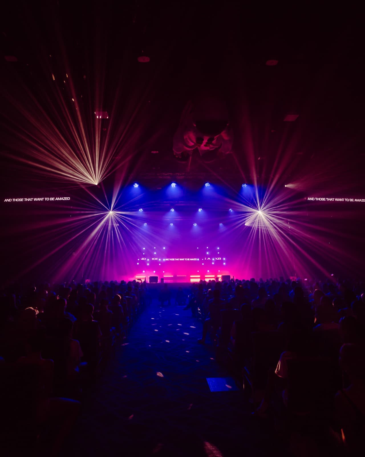 Five World stage with purple lighting and wide LED screen content.