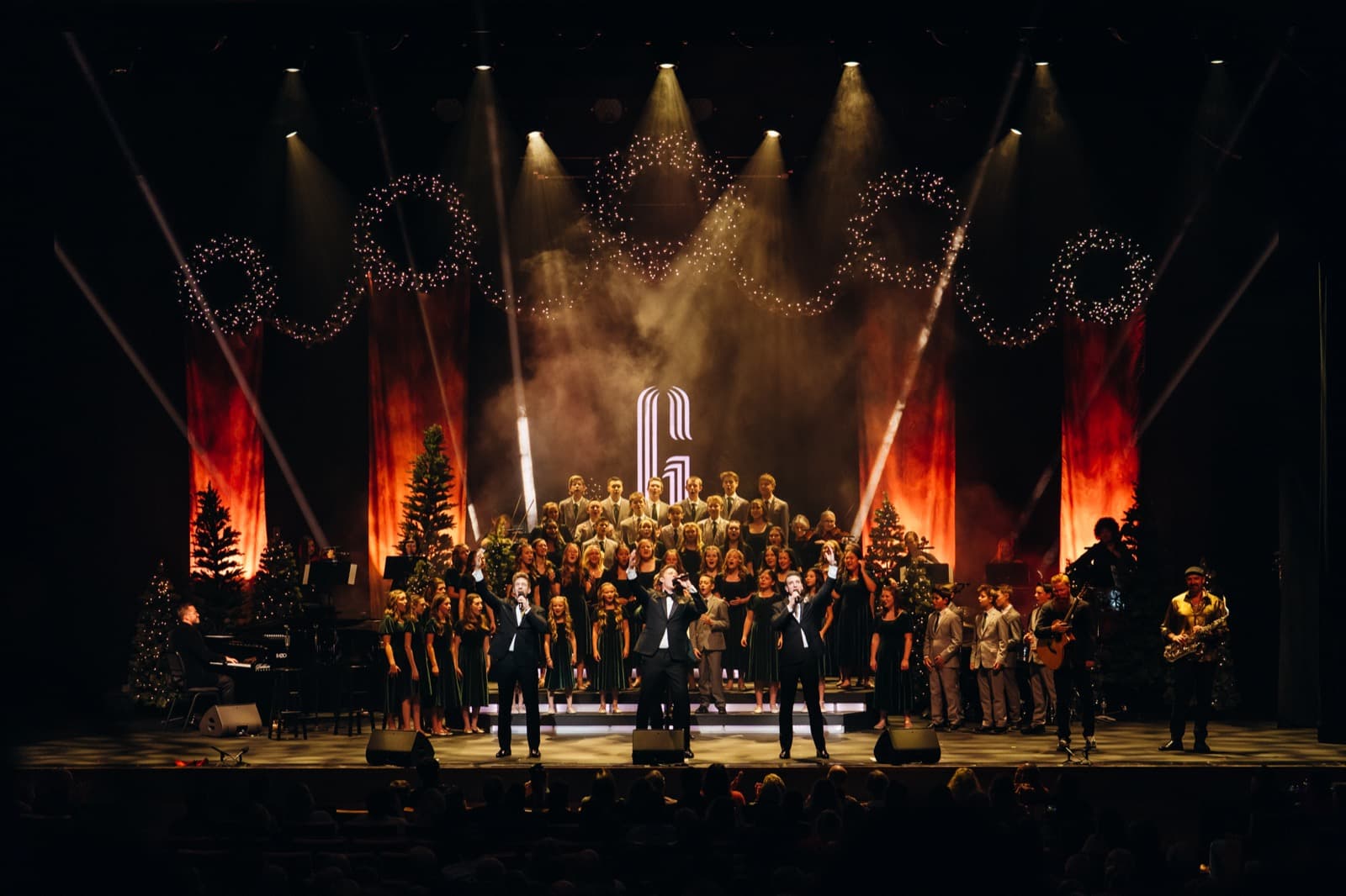 GENTRI stage finale look with amber lighting and performers across the stage.